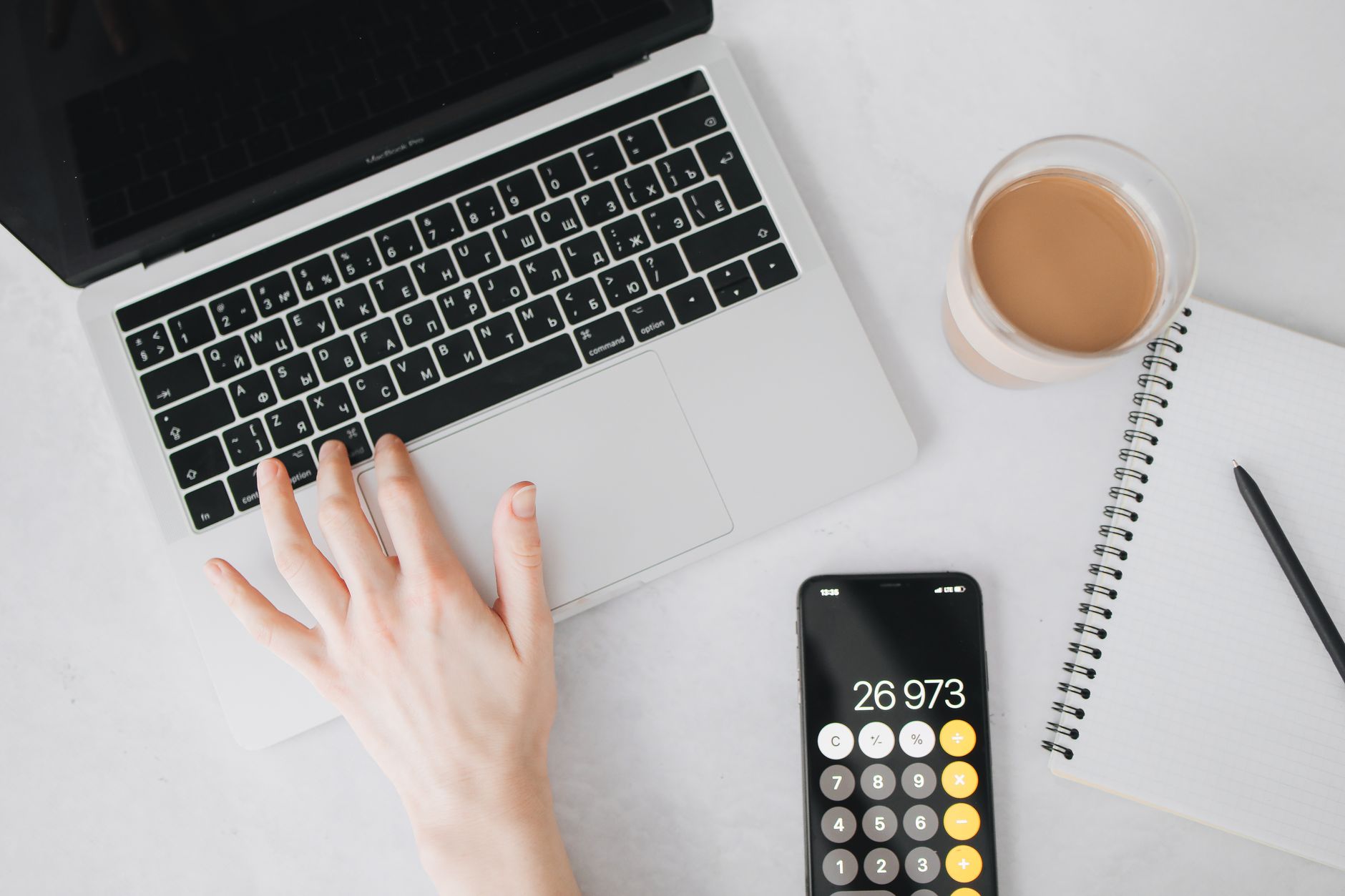 Desk with calculator, tax forms to sign